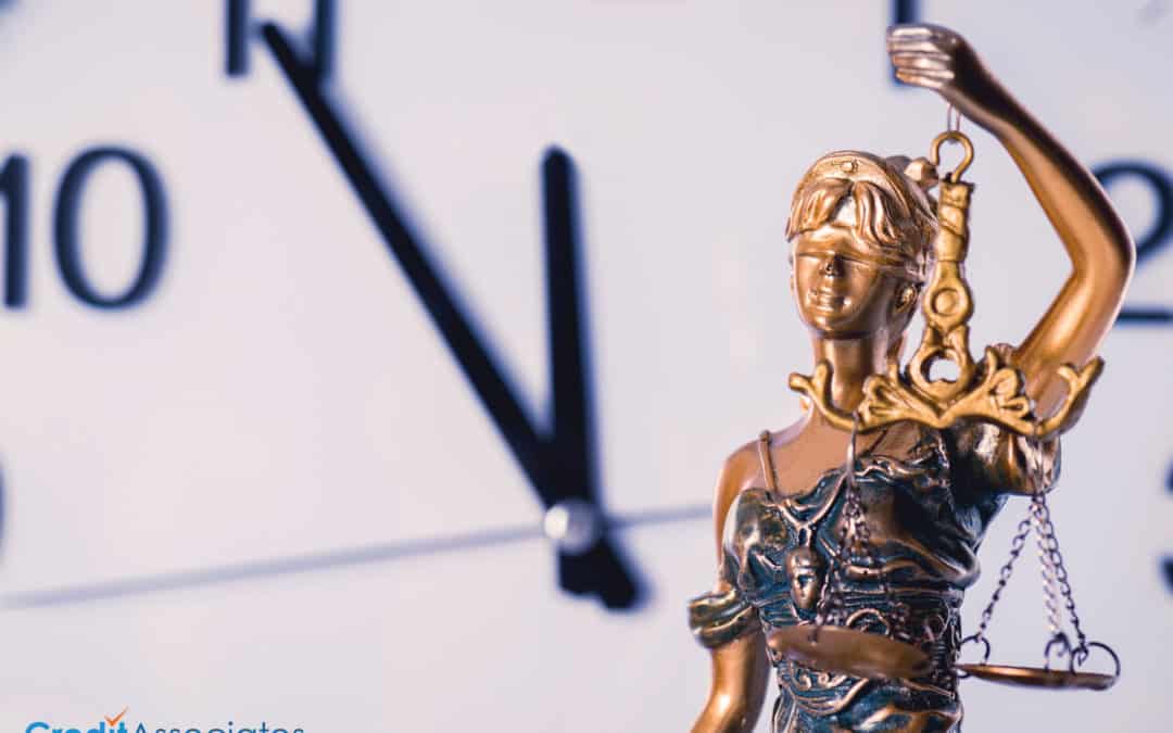 Blindfolded Lady Justice with a clock in the background